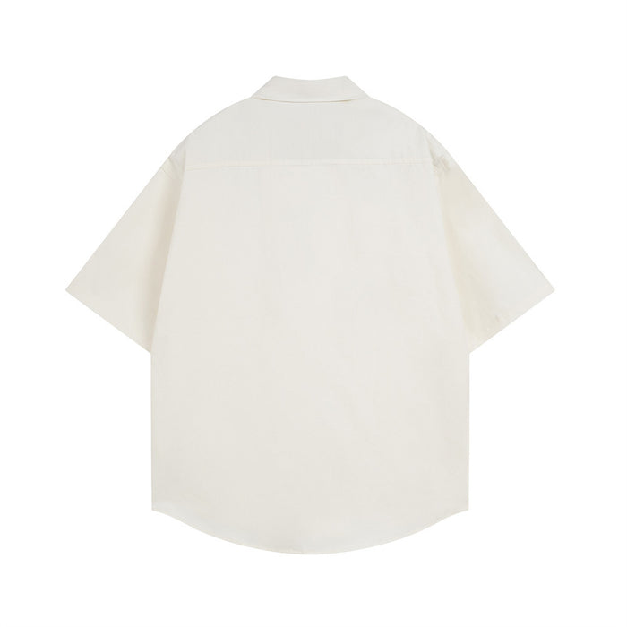 Cream short sleeve button-down shirt shown from the back with curved hem