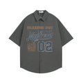 Dark gray short sleeve button-down shirt with American varsity graphic on the front