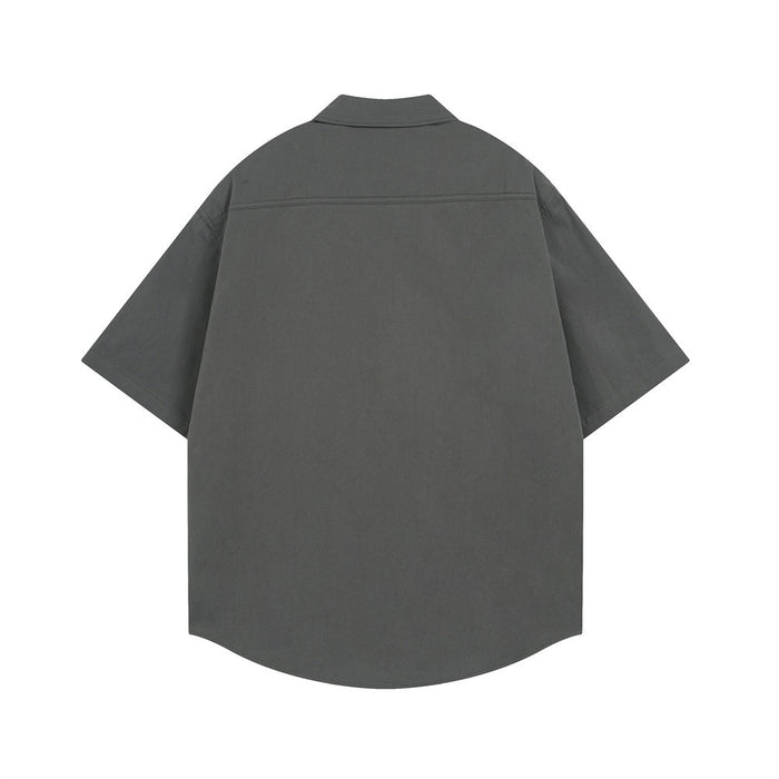 Dark gray short sleeve button-down shirt shown from the back with curved hem