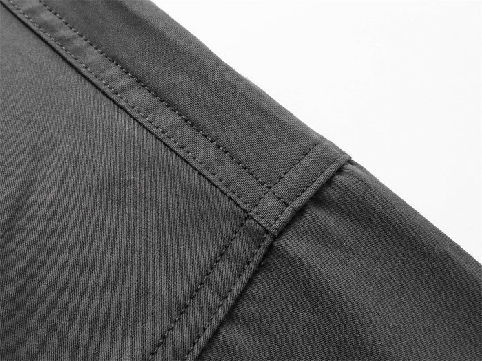 Close-up of shoulder seam and stitching on dark gray shirt