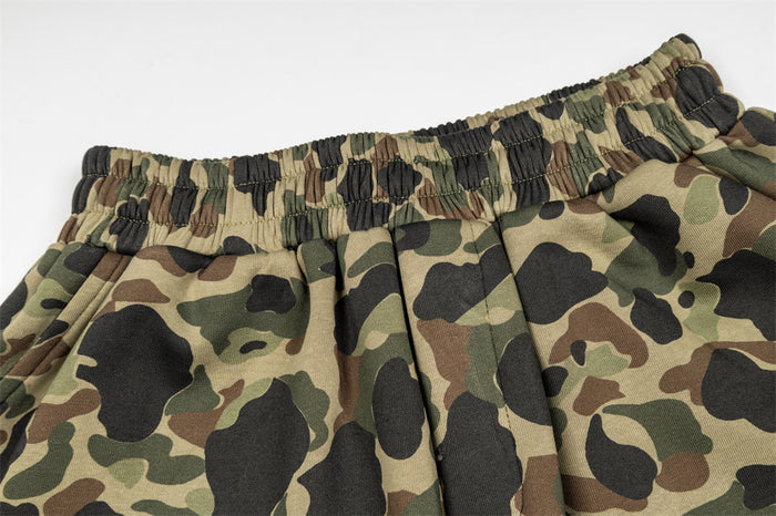 Close-up of olive camouflage shorts waistband with elastic gathering and stitched pleats