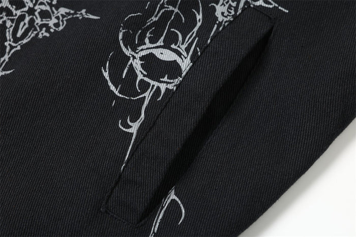 Close-up of black jacket side seam and printed sleeve area
