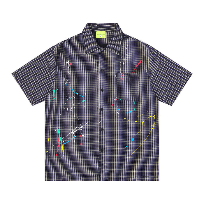 Men's oversized short sleeve plaid shirt with multicolor paint splatter embroidery on navy grid-check fabric, front and back