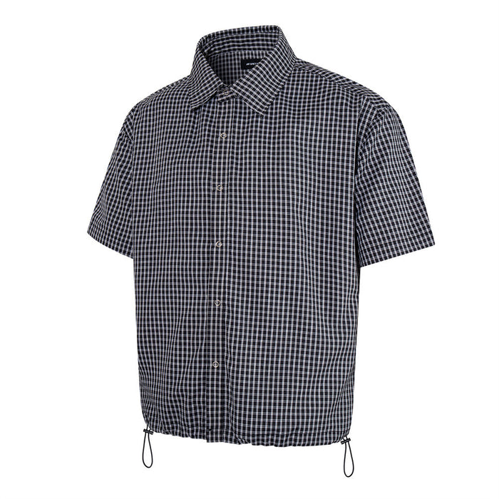 Black plaid short sleeve button-up shirt with drawstring hem, front view