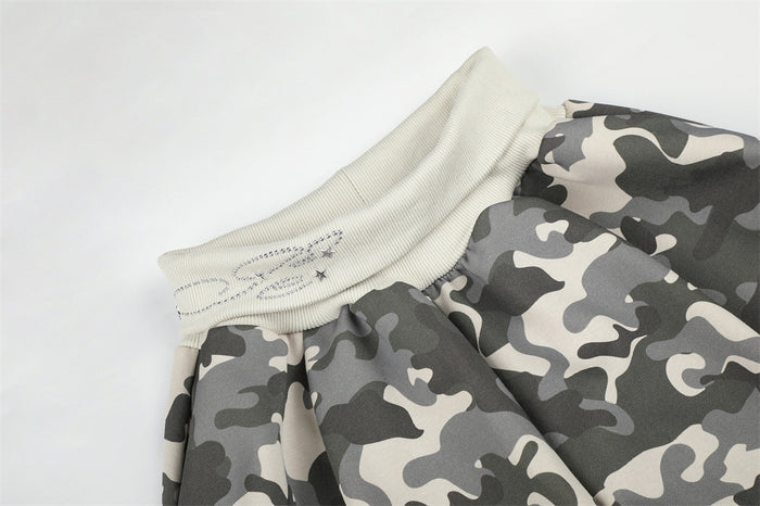 Close-up of gray camo pants waistband with ribbed elastic and star rhinestone detail