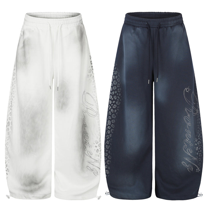 White and navy wide leg sweatpants with tie-dye fade, leopard print sides and script graphic