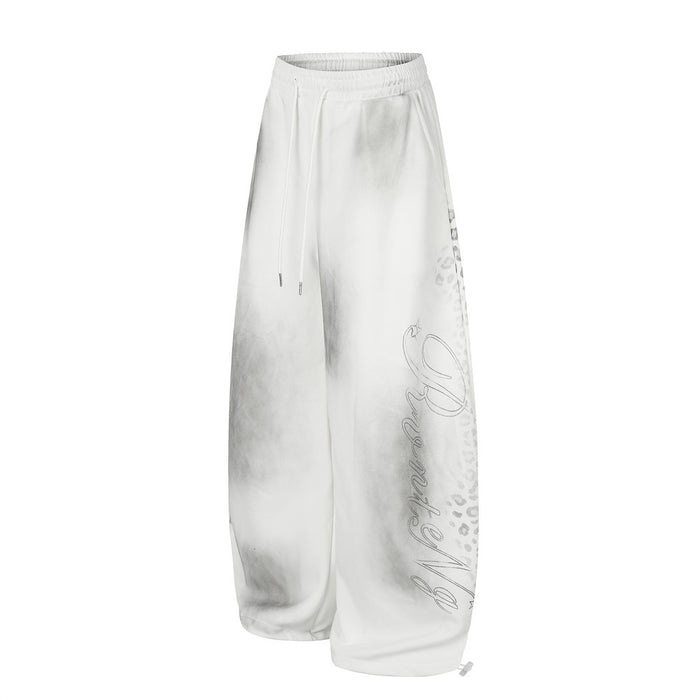 White wide leg sweatpants with tie-dye wash, leopard print side panel and script graphic