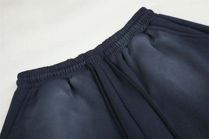 Close-up of navy sweatpants elastic waistband and drawstring detail