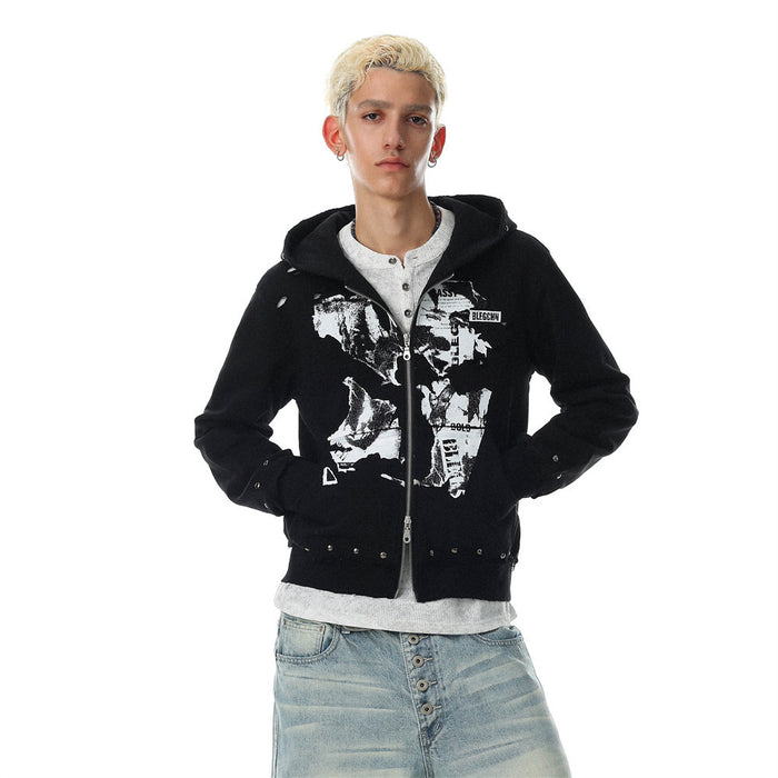 Men's black zip up hoodie with abstract collage graphic print, metal stud hem detail, and distressed finish