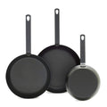 Set of three carbon steel frypans with long handles, sizes 8, 10, and 12, shown upright.