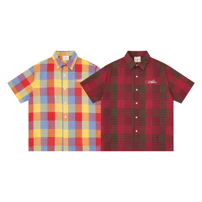 Two short sleeve button-up plaid shirts, one multicolor mosaic check and one burgundy check, displayed side by side