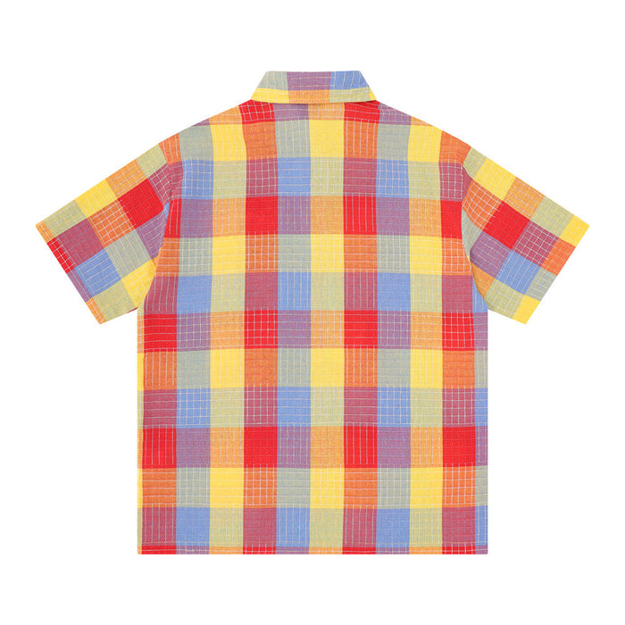 Oversized short sleeve button-up shirt with colorful mosaic plaid pattern on a white background