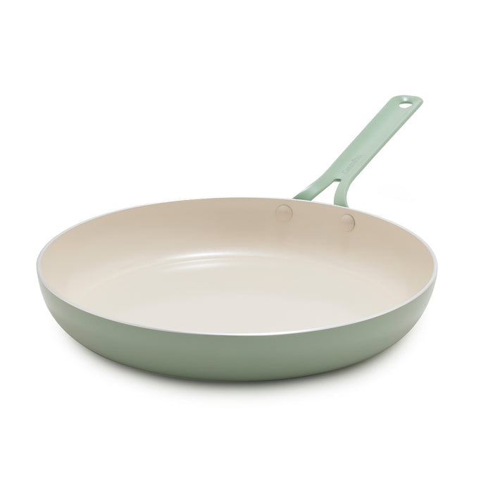 Green frying pan on a white background