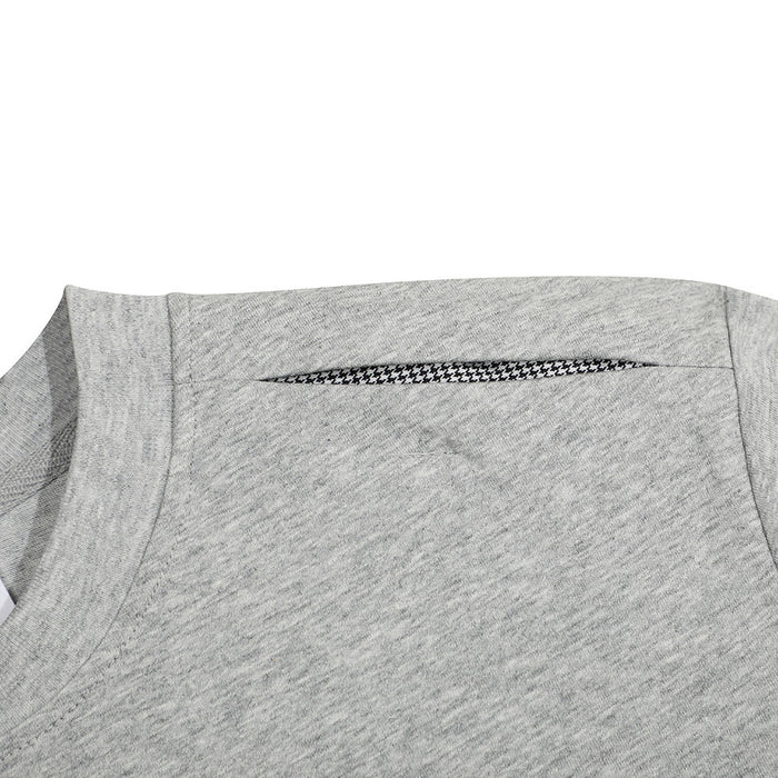Close-up of a heather gray oversized crewneck T-shirt with shoulder seam detail and patterned trim insert