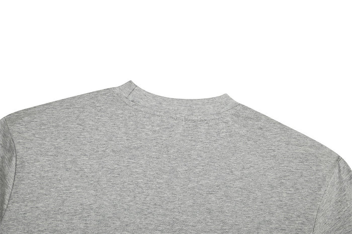 Gray oversized crewneck T-shirt with visible shoulder stitching and relaxed fit on a white background
