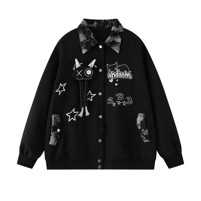 Front view of black varsity jacket with patchwork plaid collar, cat graphic, stars and button closure