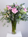 Large pink lisianthus, alstroemeria and eucalyptus bouquet in trumpet glass vase
