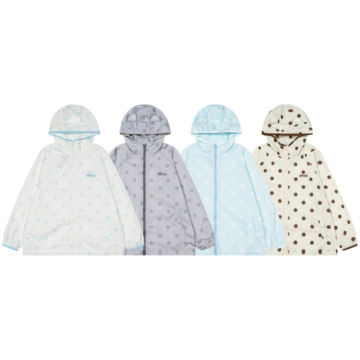 Four polka dot hooded windbreaker jackets in white, gray, blue, and cream, front view