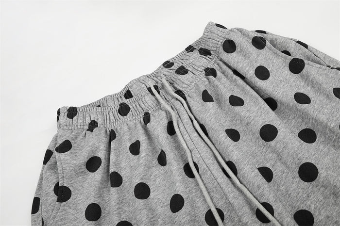 Close-up of gray polka dot pants with elastic waist and drawstring