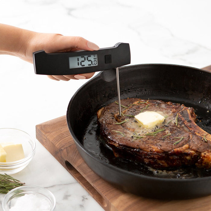 PRO Ultra-Fast Thermocouple inserted into a steak in a skillet with butter and rosemary.