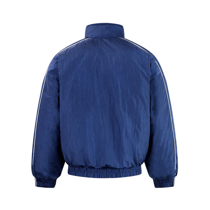 Blue track jacket back view with white piping along the shoulders and sleeves