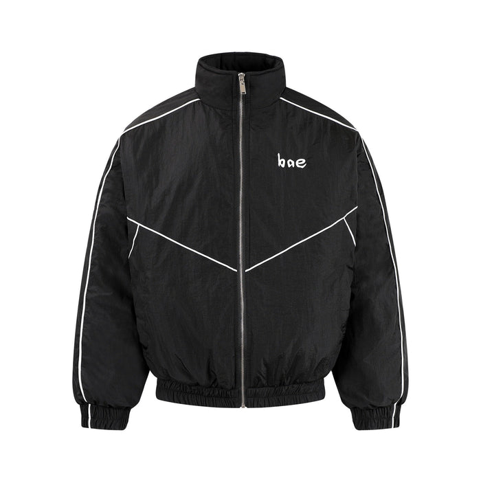 Black zip-up track jacket with white piping and bae chest print, front view