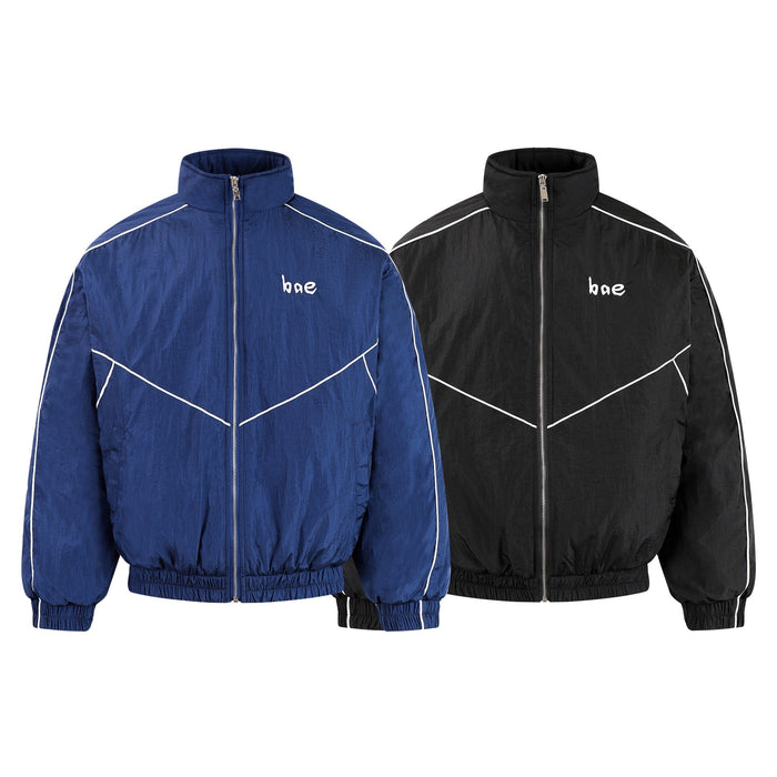 Blue and black track jackets shown side by side, front views with white piping