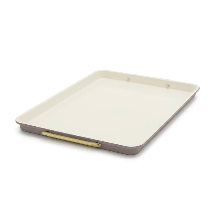 Reserve Bakeware 13″ x 18″ half sheet pan in latte with a cream interior, gold-toned handle, and aluminized steel construction.
