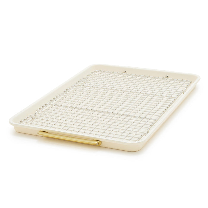 Cream half sheet pan with gold-tone handles and matching cooling rack, nonstick finish, two-piece set.