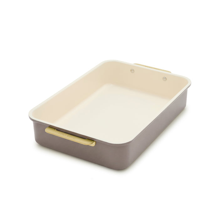 Reserve 13″ x 9″ rectangular aluminized steel pan in latte with a cream interior and gold-toned handles.