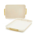 Two cream-colored sheet pans with gold handles, shown as a 2-piece bakeware set.