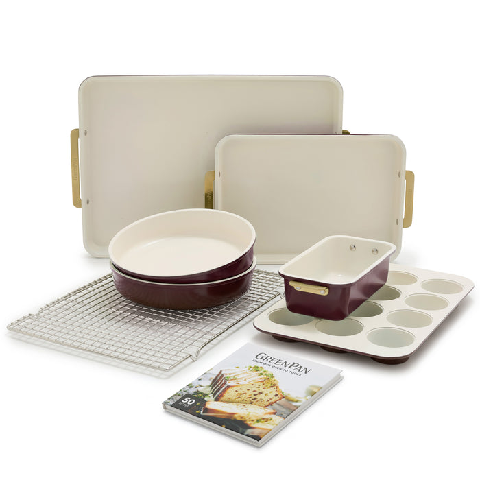 Reserve Bakeware 7-piece set in bordeaux red and cream aluminized steel, including a cooling rack and recipe book.