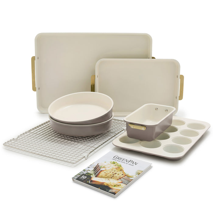 Reserve 7-piece latte bakeware set, including heavy-gauge aluminized steel pans, loaf tin, muffin tray, cooling rack, and recipe book.