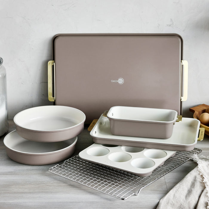 Reserve Bakeware 7-piece set in latte-colored heavy-gauge aluminized steel with light-colored interiors.