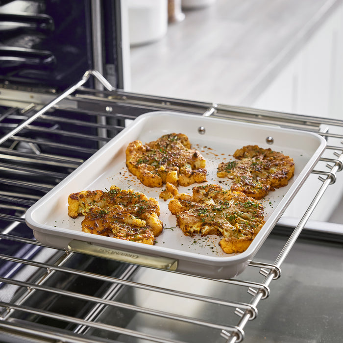 Roasted cauliflower in a Latte Reserve Bakeware 7-piece set baking pan on an oven rack.