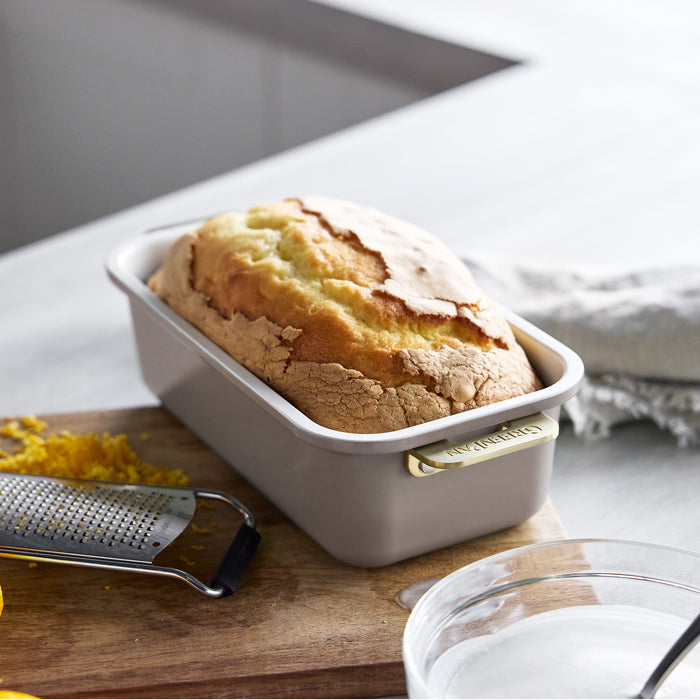 Loaf of bread in a latte rectangular Reserve Bakeware pan with gold-tone handles.