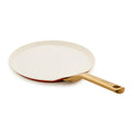 Crepe pan with a gold handle on a white background