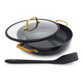 Black ceramic everyday pan with gold handles, glass lid, and included spatula shown together.