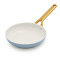 Light blue frying pan with a gold handle on a white background