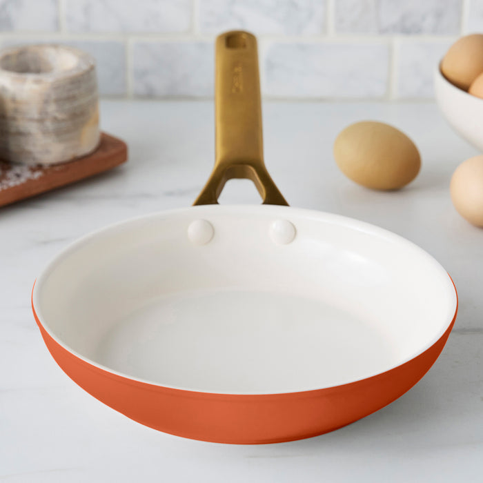 Dark orange frypan on a kitchen counter