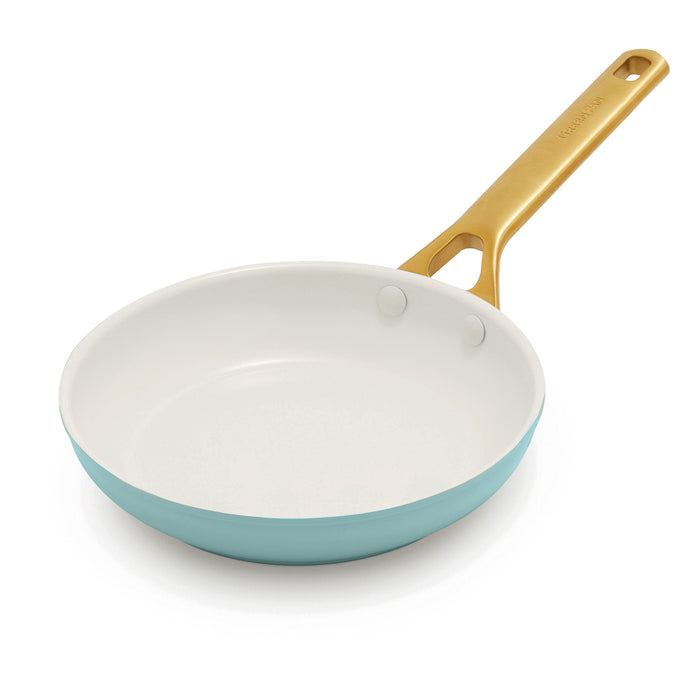 Light blue frypan pan with a gold handle on a white background