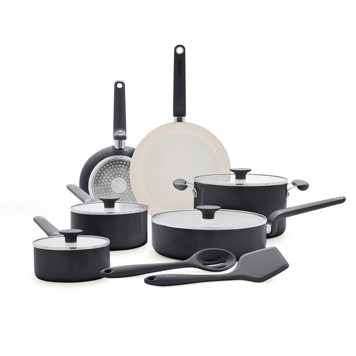 12-piece black ceramic cookware set with pans, lids, spatula, and spoon arranged on a white surface.