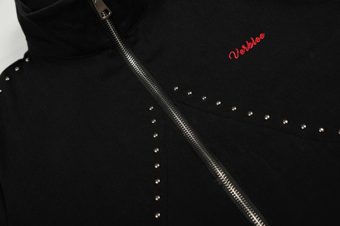 Close-up of black jacket chest with diagonal zipper and red embroidered logo