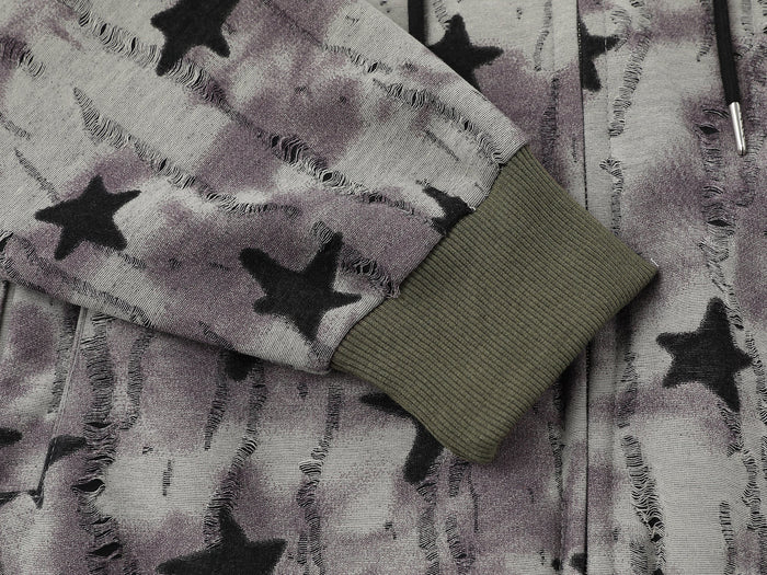 Close-up of sleeve with olive ribbed cuff and faded star print fabric