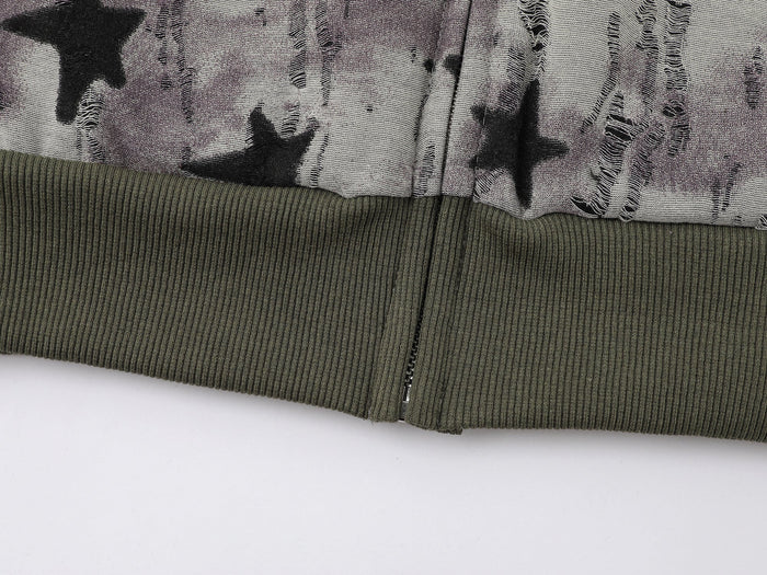 Close-up of lower hem on star print hoodie with olive ribbed band