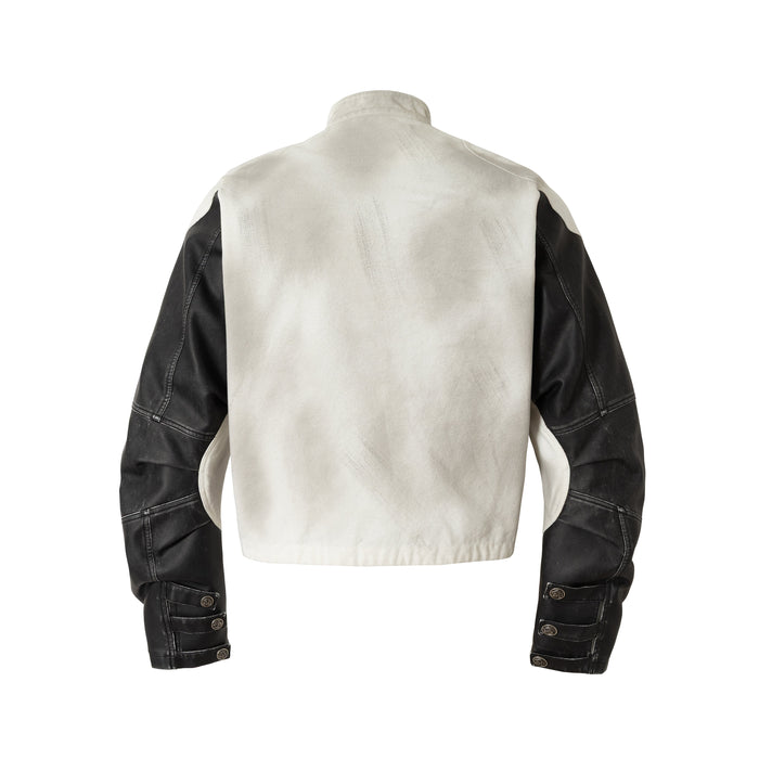 Back view of cream jacket with black sleeves and snap cuffs
