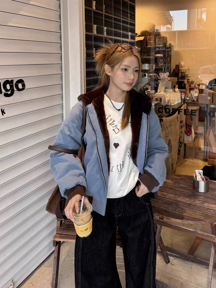 Model wearing light blue fur-lined zip-up hoodie with white graphic T-shirt