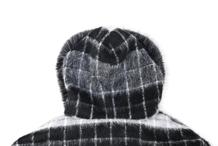 Close-up of fur-lined hood on black and gray plaid jacket