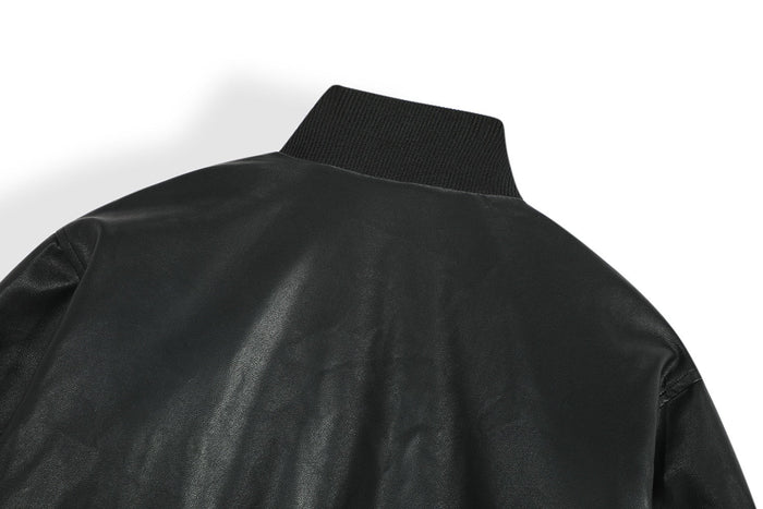 Close-up of the back shoulder area on a black PU bomber jacket