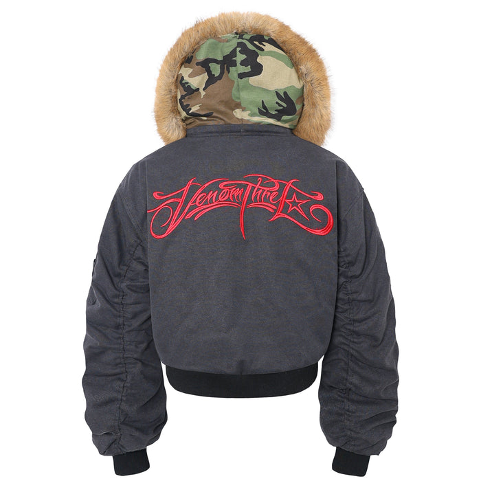 Back view of black bomber jacket with fur-trim hood and large red embroidered script
